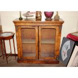 A 19th Century walnut and marquetry display cabinet, the interior shelves enclosed by a pair of