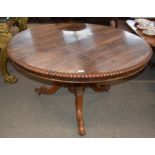 A 19th Century rosewood snap top dining table, having gadrooned border raised on an octagonal