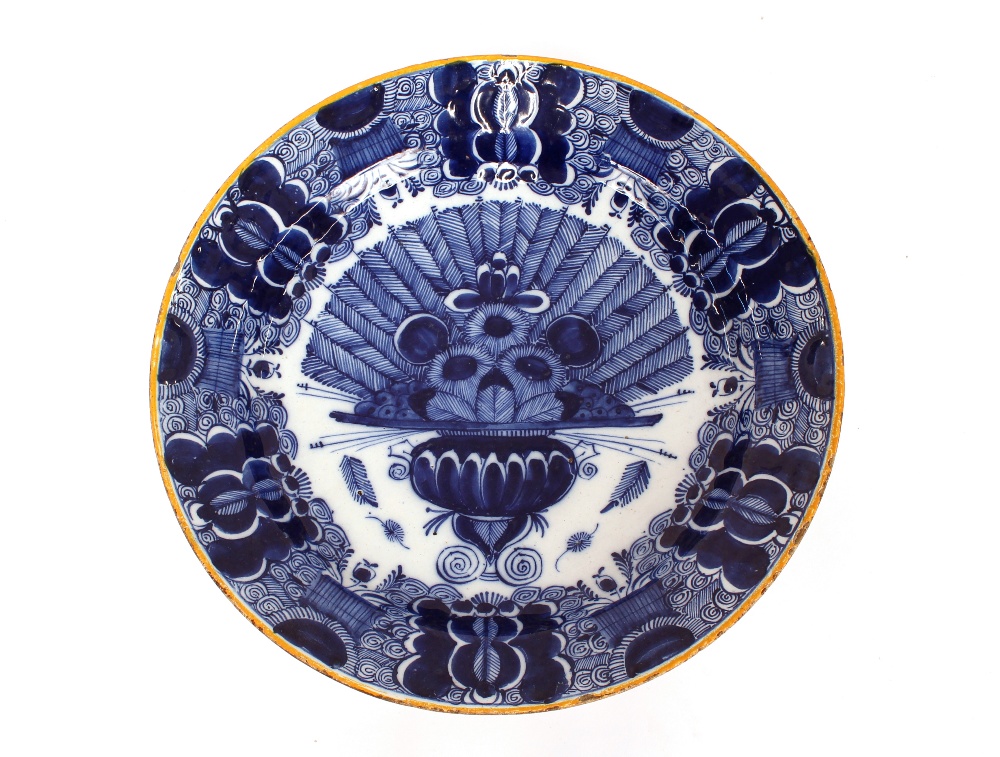 A pair of Delft shallow dishes, decorated central vase of flowers and foliate borders, 31cm - Image 3 of 4