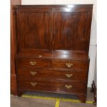 A 19th Century mahogany cabinet on chest, the upper shelves enclosed by a pair of moulded panel