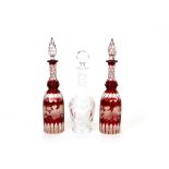 A pair of 19th Century ruby flash decanters, having vine etched decoration and spike shaped