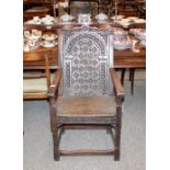 An antique oak Wainscot chair, having foliate carved back and solid seat raised on twist front