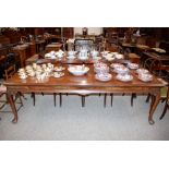 A large mahogany dining table, raised on cabriole supports and pad feet, 240cm x 105cm