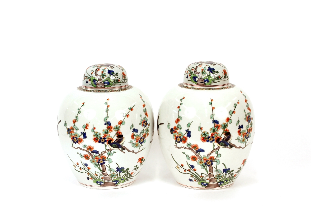 A pair of Chinese ginger jars and covers, having floral and bird decoration, 31cm high