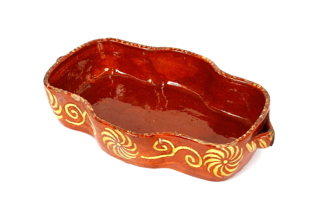 A late 18th / early 19th Century pottery treacle ware oblong dish, having twin side handles, 33cm; - Image 2 of 2