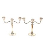 A pair of modern silver three light candelabra, weighted bases, 19cm high