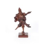 A 19th Century Chinese root wood carving of a fisherman, raised on later base, 25cm high overall