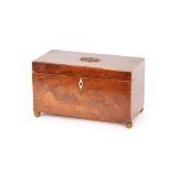 A 19th Century mahogany and box wood strung tea caddy, the hinged lid with foliate embossed brass