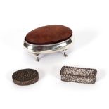 A silver oval dressing table pin cushion / trinket box; a small silver hinged pin box with