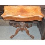 A Victorian walnut serpentine fronted card table, raised on a carved baluster column and quadruple