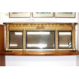A 19th Century gilt framed triple chimney mirror, with ball decoration to the shaped pediment,