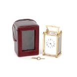A brass cased carriage timepiece, white enamel Roman numeral dial, angular swing handle, 13.5cm high