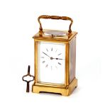 A brass cased striking carriage clock, having repeat button, bevelled glass, angular swing handle,