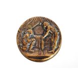 A 19th Century German yellow metal picture button depicting enema treatment, 2.7cm dia.