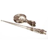 A large Victorian steel button hook, with figural silver handle London 1888, 41cm long; and an Art