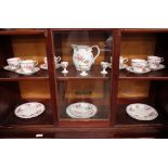 An Aynsley tea set comprising six tea cups and saucers, three small plates, six medium plates, and a