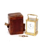 A brass cased carriage clock, striking movement, white enamel Roman numeral dial enclosed by