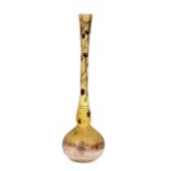 A Daum Nancy vase, having trailing foliage to the slender elongated neck, baluster base decorated