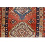 An antique Middle Eastern runner stylised field on ochre and blue ground, 85cm x 320cm