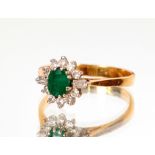 An 18ct gold emerald and diamond cluster ring, approx. total weight 3gms