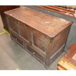 An antique oak marriage chest, initialled R.W. and bearing date for 1694, hinged lid above triple