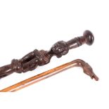 A carved antique walking stick, with horses head handle; and an African carved ebony figural walking
