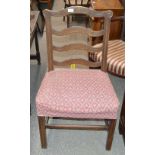 A pair of 19th Century provincial oak ladder back dining chairs, raised on square chamfered supports