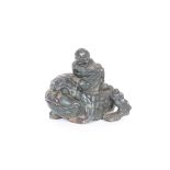 A Chinese hardstone group, depicting a figure seated on a grotesque beast, 20cm long x 17cm high