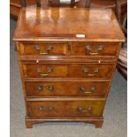 A mahogany and cross banded chest, of two short and three long graduated drawers fitted brushing