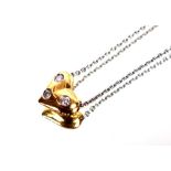 An 18ct gold Tiffany heart shaped pendant, set with three diamonds