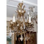 A Rococo design six branch chandelier, with cut glass pear shaped drops