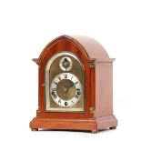 A chiming mantel clock, in mahogany lancet shaped case, the brass and steel dial with Roman