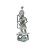 An unusual Ethnic bronze figure, depicting a man carrying clubs, raised on a pierced base, 28cm high