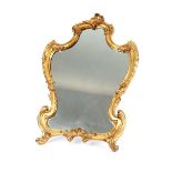 A good quality late 19th Century gilded bronze easel mirror, of cartouche shape having foliate