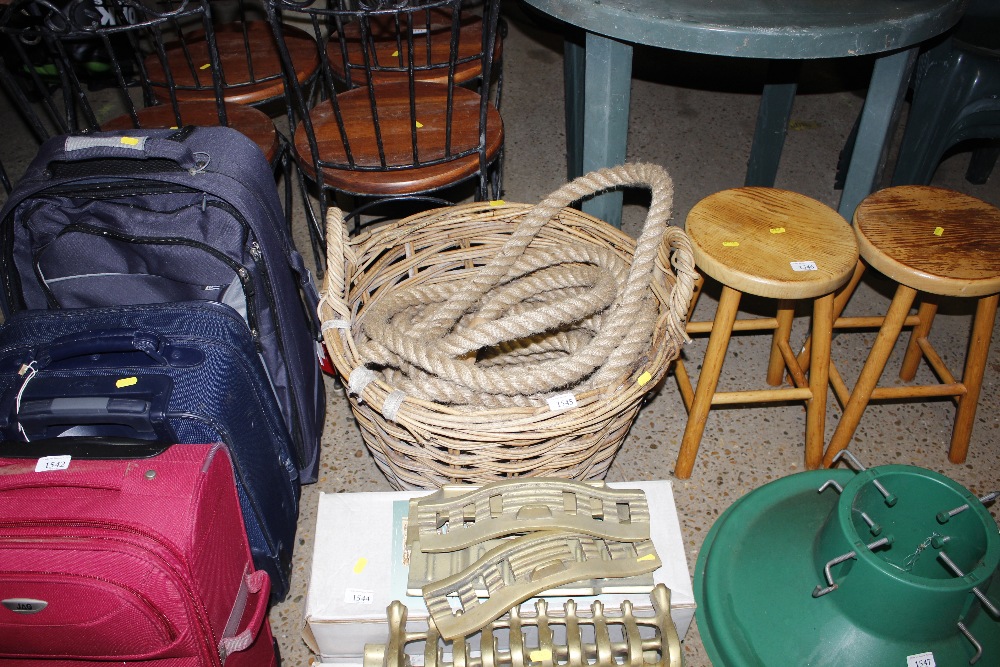 A wicker log basket with contents of rope