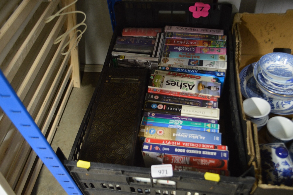 A box of VHS and DVDs