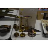 A set of balance scales; a pair of brass candle st