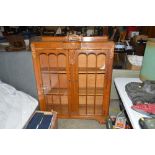 An oak glass fronted display cabinet AF