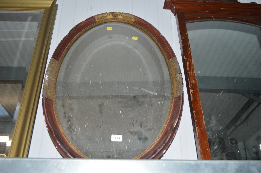 An oval gilt decorated bevel edged wall mirror