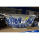 A large blue and white bowl decorated with monks