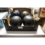 A box containing four bowling woods