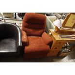 A red upholstered reclining armchair