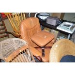 A leather swivel chair and matching footstool