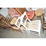 A string topped oak stool; a ladder back chair; a