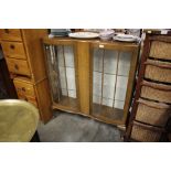 A glass fronted display cabinet with CWS lable