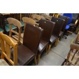 A set of four leatherette upholstered dining chair