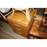 A teak effect three drawer bedside chest