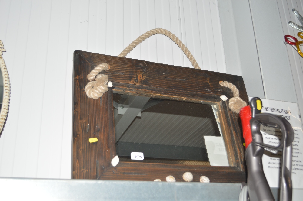 A rustic pine framed mirror decorated with shells