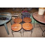 A hardwood circular topped table with a set of fou