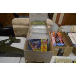 A box containing various Marvel and DC comic books